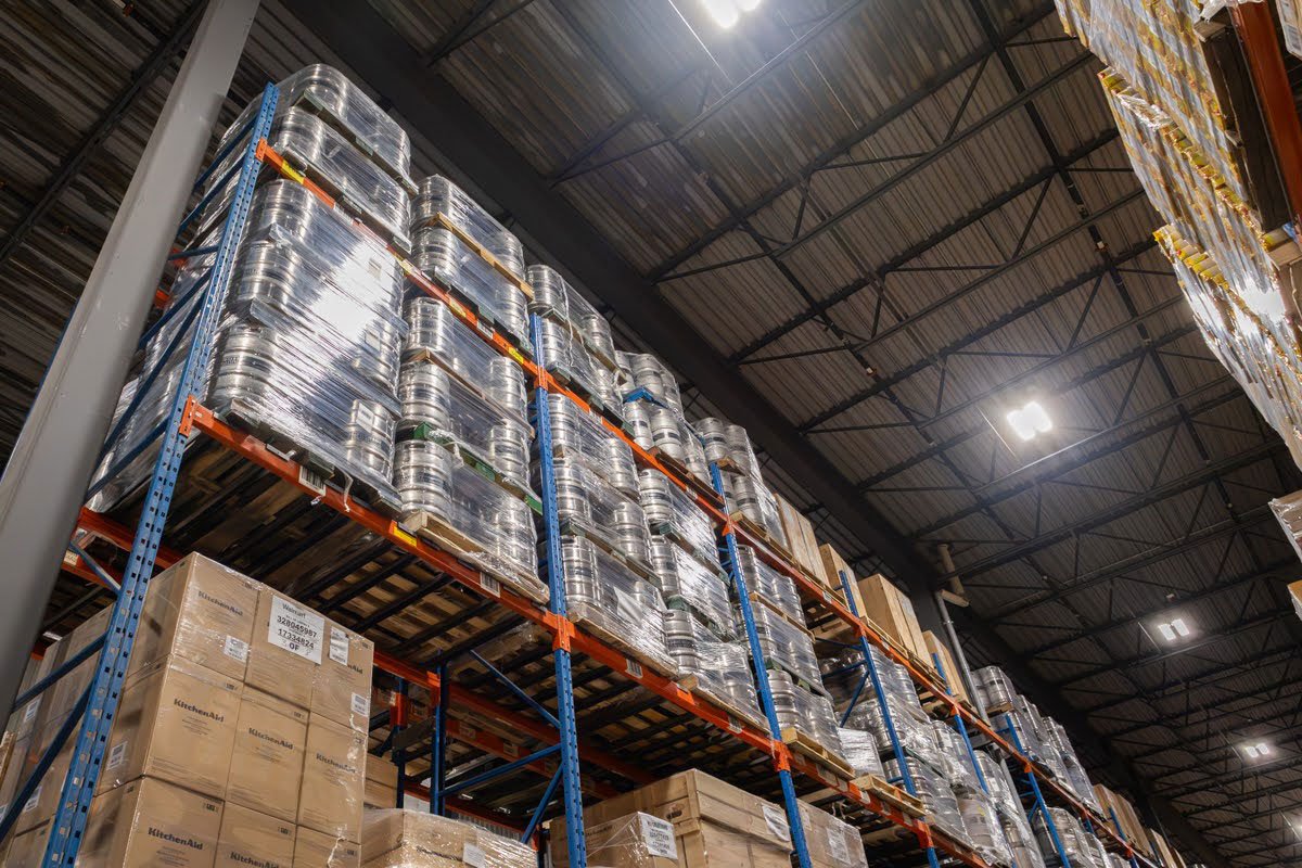 QRC Logistics warehouse for craft beer distribution, with racked inventory and kegs staged for shipping.