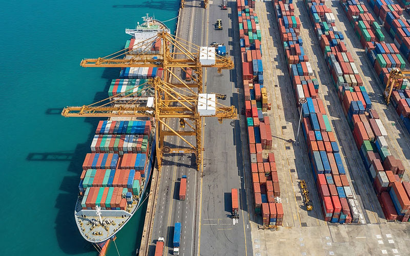 Container ship unloading at a Canadian port with cranes and freight containers for international logistics Container ship unloading at a Canadian port with cranes and freight containers for international logistics