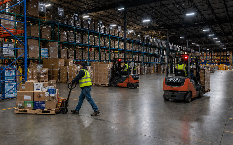 Warehouse team moving pallets with forklifts for Canadian 3PL storage, fulfillment, and distribution Warehouse team moving pallets with forklifts for Canadian 3PL storage, fulfillment, and distribution