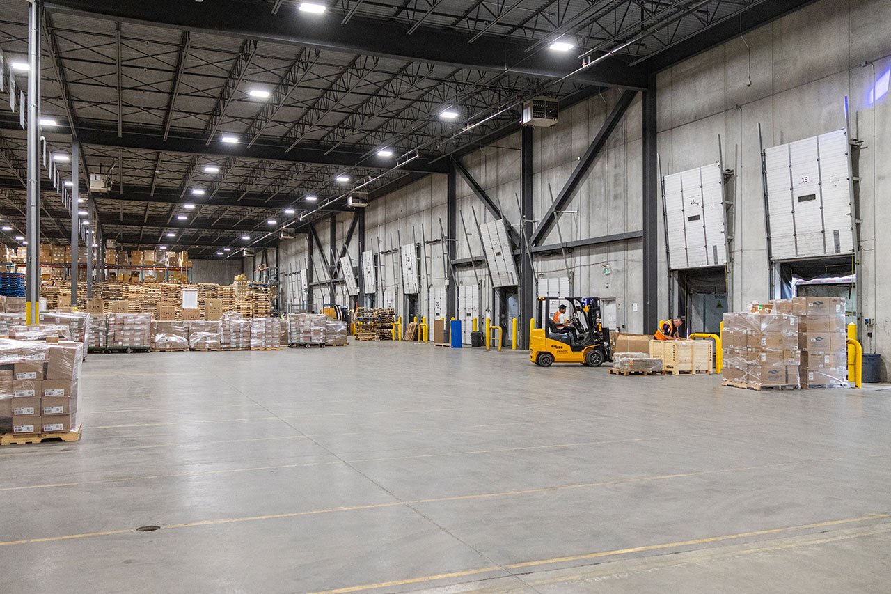 Warehouse receiving area with loading docks, pallets and forklift